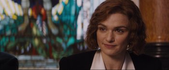 Movie still from “Denial” (2016), directed by Mick Jackson – A person wearing a suit and tie; Close Up shot, Over the shoulder angle