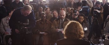 Movie still from “Denial” (2016), directed by Mick Jackson – A group of people sitting in front of a camera; Medium shot, Over the shoulder angle