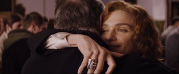 Movie still from “Denial” (2016), directed by Mick Jackson – A woman is hugging a man in a black suit; Close Up shot, Over the shoulder angle