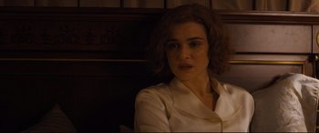 Movie still from “Denial” (2016), directed by Mick Jackson – A woman sitting in front of a wooden wall; Close Up shot, High angle