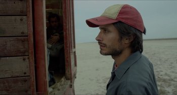 Movie still from “Desierto” (2015), directed by Jonás Cuarón – A man in a hat looking out a window; Close Up shot, Low angle