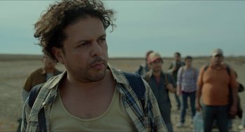 Movie still from “Desierto” (2015), directed by Jonás Cuarón – A group of people walking on the beach; Close Up shot, Low angle