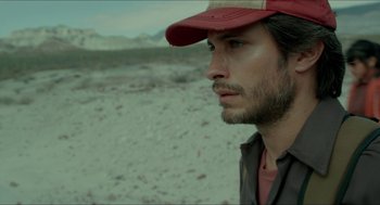 Movie still from “Desierto” (2015), directed by Jonás Cuarón – A person wearing a hat; Close Up shot, Low angle