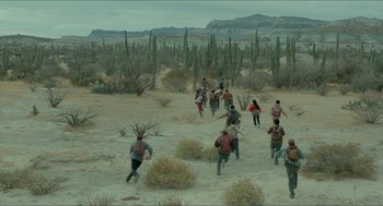 Movie still from “Desierto” (2015), directed by Jonás Cuarón – A group of people walking through the desert; Extreme Wide shot, High angle