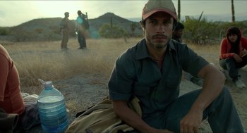 Movie still from “Desierto” (2015), directed by Jonás Cuarón – A man sitting on the ground in the desert; Close Up shot, Low angle