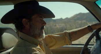 Movie still from “Desierto” (2015), directed by Jonás Cuarón – An older man in a cowboy hat driving a car; Close Up shot, Over the shoulder angle