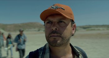 Movie still from “Desierto” (2015), directed by Jonás Cuarón – A person wearing a hat; Close Up shot, Low angle