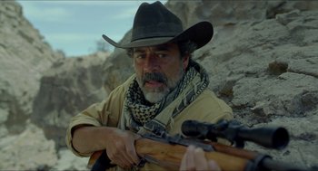 Movie still from “Desierto” (2015), directed by Jonás Cuarón – A man in a cowboy hat holding a rifle in his hand; Close Up shot, Over the shoulder angle