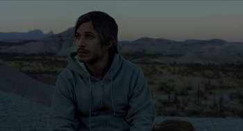Movie still from “Desierto” (2015), directed by Jonás Cuarón – A man sitting on top of a hill at dusk; Close Up shot, High angle
