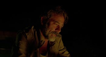 Movie still from “Desierto” (2015), directed by Jonás Cuarón – A man with a goatee is sitting in the dark; Close Up shot, Over the shoulder angle