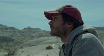 Movie still from “Desierto” (2015), directed by Jonás Cuarón – A person wearing a hat; Close Up shot, Low angle