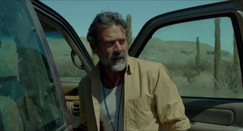 Movie still from “Desierto” (2015), directed by Jonás Cuarón – A man standing next to the door of a car; Medium shot, Over the shoulder angle