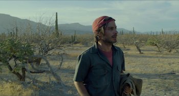 Movie still from “Desierto” (2015), directed by Jonás Cuarón – A man standing in the middle of the desert; Medium shot, Over the shoulder angle