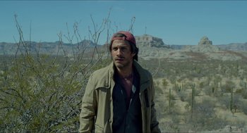Movie still from “Desierto” (2015), directed by Jonás Cuarón – A man standing in the middle of the desert; Medium shot, Over the shoulder angle