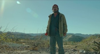 Movie still from “Desierto” (2015), directed by Jonás Cuarón – A man standing in the middle of the desert; Medium shot, Low angle