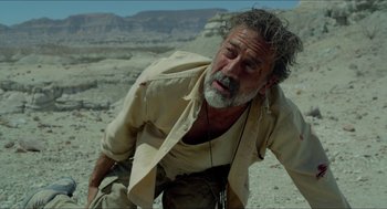 Movie still from “Desierto” (2015), directed by Jonás Cuarón – An older man with a beard is in the desert; Medium shot, Low angle