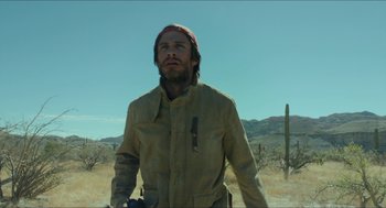 Movie still from “Desierto” (2015), directed by Jonás Cuarón – A man standing in the middle of the desert; Medium shot, Low angle