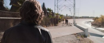 Movie still from “Destroyer” (2018), directed by Karyn Kusama – A woman standing on the side of a road; Medium shot, Over the shoulder angle