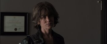 Movie still from “Destroyer” (2018), directed by Karyn Kusama – A woman in a black jacket is looking at the camera; Close Up shot, Low angle