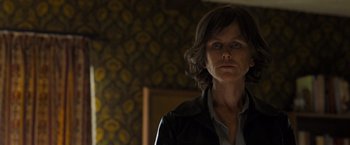 Movie still from “Destroyer” (2018), directed by Karyn Kusama – A woman in a black jacket is looking at the camera; Close Up shot, Low angle