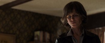 Movie still from “Destroyer” (2018), directed by Karyn Kusama – A person with a black jacket and brown hair; Close Up shot, Over the shoulder angle