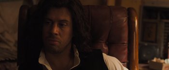 Movie still from “Destroyer” (2018), directed by Karyn Kusama – A person sitting on a couch; Close Up shot, Over the shoulder angle