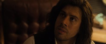 Movie still from “Destroyer” (2018), directed by Karyn Kusama – A person with long dark hair; Close Up shot, Over the shoulder angle