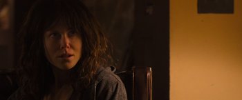 Movie still from “Destroyer” (2018), directed by Karyn Kusama – A woman sitting in front of a brown wall; Close Up shot, Over the shoulder angle