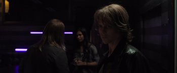 Movie still from “Destroyer” (2018), directed by Karyn Kusama – A group of people standing in a dark room; Close Up shot, Over the shoulder angle