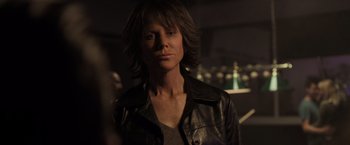 Movie still from “Destroyer” (2018), directed by Karyn Kusama – A woman in a black leather jacket looking at the camera; Close Up shot, Over the shoulder angle
