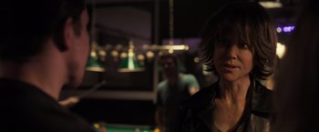 Movie still from “Destroyer” (2018), directed by Karyn Kusama – Two people standing in front of a pool table; Close Up shot, Over the shoulder angle