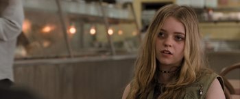 Movie still from “Destroyer” (2018), directed by Karyn Kusama – A young woman with long hair and a black necklace; Close Up shot, Over the shoulder angle