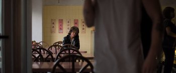 Movie still from “Destroyer” (2018), directed by Karyn Kusama – A woman sitting at a table in front of a man; Medium shot, Over the shoulder angle