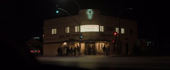 Movie still from “Destroyer” (2018), directed by Karyn Kusama – A group of people standing in front of a building; Extreme Wide shot, Low angle