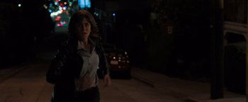 Movie still from “Destroyer” (2018), directed by Karyn Kusama – A woman running down a street at night; Medium shot, Over the shoulder angle