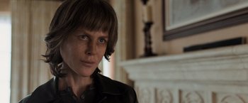 Movie still from “Destroyer” (2018), directed by Karyn Kusama – A person with a black jacket and a black shirt; Close Up shot, Over the shoulder angle