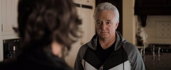 Movie still from “Destroyer” (2018), directed by Karyn Kusama – An older man looking at a younger woman; Close Up shot, Over the shoulder angle