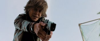Movie still from “Destroyer” (2018), directed by Karyn Kusama – A woman is holding a gun in her hand; Close Up shot, Low angle