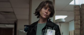 Movie still from “Destroyer” (2018), directed by Karyn Kusama – A woman in a black leather jacket looking at the camera; Close Up shot, Over the shoulder angle