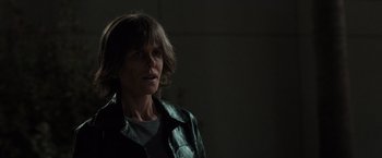 Movie still from “Destroyer” (2018), directed by Karyn Kusama – A woman in a dark room looking to her left; Close Up shot, Low angle