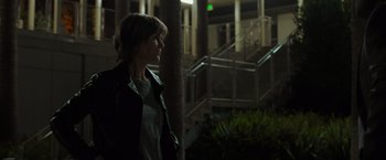 Movie still from “Destroyer” (2018), directed by Karyn Kusama – A woman standing in the dark near a building; Medium shot, Low angle