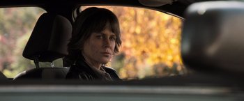 Movie still from “Destroyer” (2018), directed by Karyn Kusama – A woman sitting in the back seat of a car looking out the window; Close Up shot, Over the shoulder angle