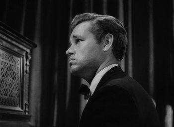 Movie still from “Detour” (1945), directed by Edgar G. Ulmer – Black and white photograph of a man in a tuxedo; Close Up shot, Low angle