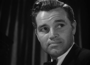 Movie still from “Detour” (1945), directed by Edgar G. Ulmer – Black and white photograph of a man in a tuxedo; Close Up shot, Low angle