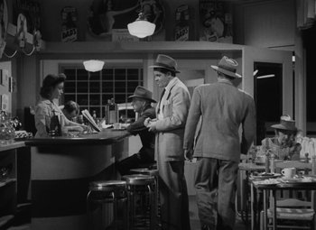Movie still from “Detour” (1945), directed by Edgar G. Ulmer – A black and white photo of people at a bar; Wide shot, High angle