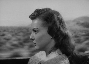 Movie still from “Detour” (1945), directed by Edgar G. Ulmer – A black and white photo of a woman in a car; Close Up shot, Low angle