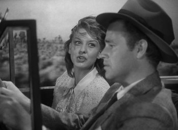 Movie still from “Detour” (1945), directed by Edgar G. Ulmer – A woman sitting next to a man in a car; Close Up shot, Over the shoulder angle
