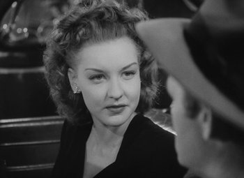 Movie still from “Detour” (1945), directed by Edgar G. Ulmer – An old photo of a woman in a black dress looking at a man; Close Up shot, Over the shoulder angle