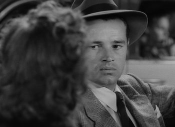 Movie still from “Detour” (1945), directed by Edgar G. Ulmer – A black and white photo of a man and a woman; Close Up shot, Over the shoulder angle