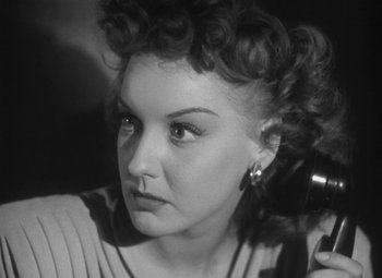 Movie still from “Detour” (1945), directed by Edgar G. Ulmer – A black and white photo of a woman with a hair dryer; Close Up shot, Low angle
